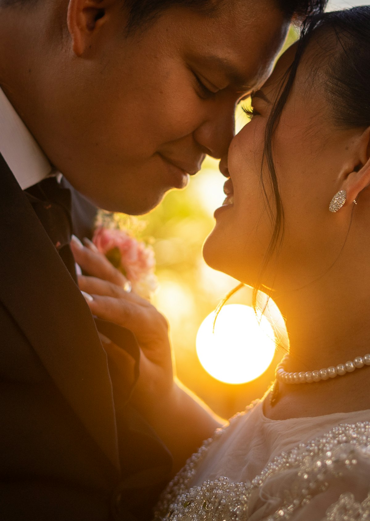 Bride and groom embracing at sunset